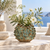 Moss green coral effect ceramic vase with white flowers styled in an elegant coastal interior