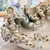 Close-up of sculpted octopus tentacles and suction cup details on cream Thai ceramic bowl