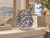 Sculptural blue and white coral ceramic vase displayed without flowers in an upscale coastal interior