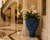 Large blue Tree of Life ceramic vase displayed as a floor accent in an elegant palace entryway corner