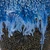 Close-up detail of the ocean blue glaze and sand dollar texture on the handmade ceramic vase