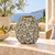 Handcrafted earth tone and blue Bouquet De Fleurs ceramic vase shown alone, highlighting its sculpted floral relief and rounded silhouette.