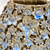 Close-up detail of the Bouquet De Fleurs vase showing dimensional handmade flowers and earth tone glaze with blue accents.