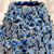 Close-up of sculpted floral relief and deep blue glaze on handmade Thai ceramic vase