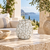 Handcrafted white Bouquet De Fleurs vase displayed without flowers on a bright coastal lanai