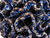 Close-up of sculpted coral formations, deep cobalt and indigo glaze, and golden-brown highlights on a handmade ceramic vase.