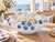 White and sapphire blue ceramic floral bowl styled in an elegant coastal dining room