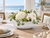 Handmade Thai green and white floral ceramic bowl with hydrangeas and orchids on a coastal dining table