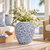 Medium light blue floral relief ceramic vase displayed without flowers in an elegant coastal interior