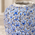 Close-up of sculpted floral relief and light blue glaze on handmade Thai ceramic vase