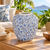 Medium light blue Bouquet De Fleurs ceramic vase styled with flowers on a warm sunlit tabletop