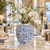 Small light blue Bouquet De Fleurs ceramic vase styled with white orchids in an elegant hotel lobby setting