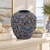 Medium deep blue floral relief ceramic vase displayed without flowers in a refined coastal interior