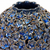 Close-up of sculpted floral relief and deep blue glaze on handmade Thai ceramic vase