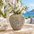 Large celadon green Bouquet De Fleurs ceramic vase styled with white orchids in a bright coastal setting