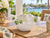 Small handmade white and green ceramic bowl displayed empty on a bright Florida waterfront lanai