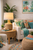 White handwoven abaca rope table lamp L150 styled beside colorful coastal seating in a bright living room.