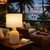 White Twisted Abaca rope table lamp L151 illuminated in a tropical evening interior with warm ambient lighting.