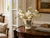 Handmade Thai cream floral ceramic vase with pale orchids and delicate wildflowers displayed on a polished wood table in a New England Victorian home.
