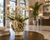 Handmade Thai cream floral ceramic vase with pale orchids and delicate wildflowers displayed in an upscale five-star hotel lobby.