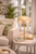 Capiz Shell Dome Table Lamp L112S styled on a side table in a bright coastal living room with warm ambient lighting.