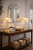 Pair of Capiz Shell Dome Table Lamps L112L styled on a console table in a bright coastal interior.