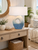 Handmade Thai Santorini ceramic table lamp styled on a console in a light neutral coastal room