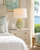 Handcrafted Thai green floral ceramic table lamp styled on a bedside table in a bright Florida coastal bedroom