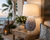 Handcrafted Thai blue blossom ceramic table lamp styled in a sophisticated interior with warm natural furnishings