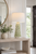 Handmade Thai white and green coral ceramic lamp styled beside a window in an elegant tropical room