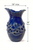 Large blue octopus ceramic vase displayed on a console in an elegant luxury hotel interior.