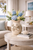Medium cream octopus ceramic vase displayed with botanical stems in an elegant resort-style interior.