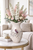 Extra large cream octopus ceramic vase styled with soft blush floral stems in an elegant coastal interior.