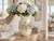 Extra large cream octopus ceramic vase filled with blue and white hydrangeas on a coastal console table.