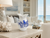 Handmade blue and white ceramic octopus vase displayed on a marble console in an upscale coastal hotel-style lobby.