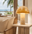 Golden Capiz Shell Mushroom Table Lamp L113S styled beside coastal seating in a bright tropical interior.