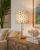 Luna Capiz Shell Table Lamp L110L styled on an accent table with warm light glowing through the genuine Capiz shell shade.