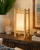 Bamboo Island table lamp L114S illuminated on an accent table in a warm tropical interior with natural bamboo details.