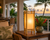 Bamboo Island table lamp V114L styled in a tropical interior with greenery and warm light glowing through the natural fabric panels.