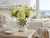 Handmade Thai green floral ceramic vase with flowers on a coastal lanai