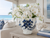 Medium sculptural floral ceramic vase styled with botanicals in a bright beach house interior.