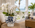 Handmade Thai blue floral ceramic vase displayed on a coastal console in an upscale beach home with ocean views