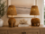 Pair of handwoven wicker elephant table lamps L149E styled in an upscale coastal interior with warm ambient lighting.