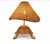 Alternate view of handwoven wicker turtle table lamp showing the sea turtle profile, shell shape and woven wicker shade.