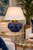 Cobalt blue sea urchin ceramic table lamp styled on an elegant bedside table