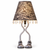 Eve designer table lamp with a snake skin print shade, clear bead trim, silver sculptural legs, and patterned sandal feet on white.