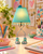 Eve Lamp jade green designer table lamp styled on a vanity table in a fun feminine room setting
