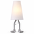 Adam table lamp illuminated on a white background, featuring a tapered white cotton shade, silver cast metal legs, and sculpted bare feet.