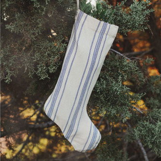 Handcrafted natural blue cotton ticking stripe holiday stocking with ample space for gifts, perfect for your fireplace, mantle, tree or staircase decoration.