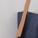 The Archer Jute Tote Bag in indigo, a gorgeous accessory, with a jute canvas exterior and interior cotton lining, along with a strong, leather handle it's perfect for everyday use or trips to the farmer's market.